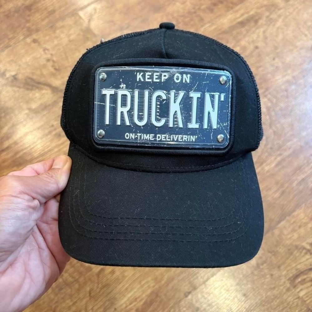 Black KEEP ON TRUCKIN trucker hat with license plate design